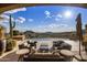 Luxury patio with comfortable seating overlooking the infinity pool and mountain views at 9920 E Honey Mesquite Dr # 155, Scottsdale, AZ 85262