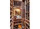 Well-stocked wine cellar with custom wood shelving and a decorative carving at 9920 E Honey Mesquite Dr # 155, Scottsdale, AZ 85262
