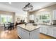 Bright kitchen with island, stainless steel appliances, granite countertops and light wood floors at 10155 E Bella Vista Dr, Scottsdale, AZ 85258