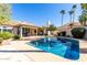 Backyard pool surrounded by lush landscaping and a beautiful home at 10155 E Bella Vista Dr, Scottsdale, AZ 85258