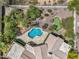 Aerial view of an estate backyard with a sparkling blue pool, outdoor living spaces, and lush landscaping at 10290 N 117Th Pl, Scottsdale, AZ 85259