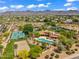 Aerial view of a property featuring tennis court, pool, lush greenery, and mountain views at 10290 N 117Th Pl, Scottsdale, AZ 85259
