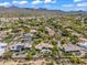 An aerial view showcasing the community and surrounding area, including other houses and desert landscape at 10290 N 117Th Pl, Scottsdale, AZ 85259