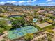 Aerial view showcasing tennis courts, lush landscaping, and neighboring properties in the community at 10290 N 117Th Pl, Scottsdale, AZ 85259