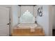 Relaxing bathroom featuring a soaking tub and elegant glass block window at 10290 N 117Th Pl, Scottsdale, AZ 85259