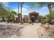 Stunning home exterior featuring a grand entrance, beautiful landscaping, and charming water fountain at 10290 N 117Th Pl, Scottsdale, AZ 85259