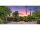 Charming single-story home boasts lush landscaping, mature trees, and a stone facade, offering exceptional curb appeal at 10290 N 117Th Pl, Scottsdale, AZ 85259