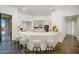 Open kitchen features white cabinetry, stainless appliances, a large island with breakfast bar, and unique flooring at 10290 N 117Th Pl, Scottsdale, AZ 85259