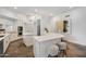 Open kitchen features white cabinetry, stainless appliances, large island with breakfast bar, and unique flooring at 10290 N 117Th Pl, Scottsdale, AZ 85259