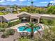 Aerial view of a backyard pool and patio area with tile pavers and lush landscaping at 10290 N 117Th Pl, Scottsdale, AZ 85259