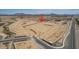 Aerial view of new construction site in desert area near a road and distant mountains at 1275 E Ridgerock Loop, Casa Grande, AZ 85122