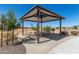 Community picnic area with shaded pavilion, tables, benches and mature trees at 1275 E Ridgerock Loop, Casa Grande, AZ 85122