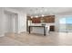 Open kitchen with stainless steel appliances, center island, and easy access to the outdoor patio at 1275 E Ridgerock Loop, Casa Grande, AZ 85122