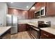 Modern kitchen featuring stainless steel appliances, granite countertops, and abundant cabinet space at 1275 E Ridgerock Loop, Casa Grande, AZ 85122