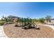 Community playground with climbing structure, slides, and bench seating area at 1275 E Ridgerock Loop, Casa Grande, AZ 85122