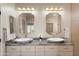 Elegant bathroom with dual sinks, granite countertop and gold fixtures at 12860 W Junipero Dr, Sun City West, AZ 85375