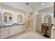 Modern bathroom featuring double sinks, a vanity, and a walk-in shower at 12860 W Junipero Dr, Sun City West, AZ 85375