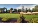 Landscaped community entrance with a fountain, vibrant flowering shrubs and a manicured lawn at 12860 W Junipero Dr, Sun City West, AZ 85375