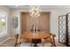 Chic dining room with a statement light fixture, and modern wood paneled accent wall at 12860 W Junipero Dr, Sun City West, AZ 85375