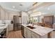 Open kitchen boasts granite countertops, stainless appliances, and views of the dining area at 12860 W Junipero Dr, Sun City West, AZ 85375