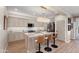 Modern kitchen with marble countertops, tiled backsplash, and seating at the kitchen island at 12860 W Junipero Dr, Sun City West, AZ 85375