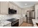 Stylish kitchen featuring modern appliances, granite countertops, and ample cabinet storage at 12860 W Junipero Dr, Sun City West, AZ 85375