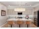 Bright kitchen featuring modern appliances, stylish light fixture, and center island with seating at 12860 W Junipero Dr, Sun City West, AZ 85375