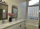 Bathroom featuring double vanity, marble countertops, soaking tub and window at 1444 W Spruce Dr, Chandler, AZ 85286