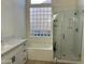 Bright bathroom with a glass block window, shower and soaking tub at 1444 W Spruce Dr, Chandler, AZ 85286