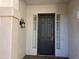 A welcoming front entrance features a dark door with sidelights and a classic lantern fixture at 1444 W Spruce Dr, Chandler, AZ 85286