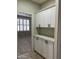 Hallway with built-in cabinets and a countertop, leading to a room with white shuttered windows at 1444 W Spruce Dr, Chandler, AZ 85286