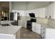 Bright kitchen features quartz countertops, stainless steel appliances, and white cabinets at 1444 W Spruce Dr, Chandler, AZ 85286