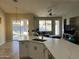 Open floor plan with living area, kitchen island, pool and patio visible through sliding glass doors at 1444 W Spruce Dr, Chandler, AZ 85286