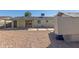 Spacious backyard featuring a covered patio, rock landscaping, and convenient access to the home's interior at 1646 W Fairmont Dr, Tempe, AZ 85282