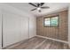 Bedroom featuring brick accent wall, wood-look flooring and a closet at 1646 W Fairmont Dr, Tempe, AZ 85282