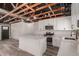 Bright kitchen features white cabinetry, an island, stainless appliances, and exposed ceiling beams at 1646 W Fairmont Dr, Tempe, AZ 85282