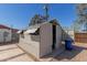 Backyard shed structure with open door and rock landscaping at 1646 W Fairmont Dr, Tempe, AZ 85282