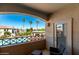 Relaxing balcony view of a community pool and palm trees, with comfortable seating at 1941 S Pierpont Dr # 2141, Mesa, AZ 85206