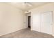 Well-lit bedroom featuring a ceiling fan, plush carpeting and a closet with sliding doors at 1941 S Pierpont Dr # 2141, Mesa, AZ 85206