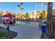 Community pool area with lounge chairs, tables, and palm trees at 1941 S Pierpont Dr # 2141, Mesa, AZ 85206
