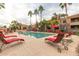 Resort-style community pool area with lounge chairs and tropical palm trees at 1941 S Pierpont Dr # 2141, Mesa, AZ 85206