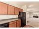 Kitchen featuring wood cabinetry and appliances, adjacent to a living space at 1941 S Pierpont Dr # 2141, Mesa, AZ 85206
