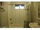 Bathroom featuring a shower over a tub with shower curtain, window, and sink at 2215 W Highland Ave, Phoenix, AZ 85015