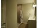 Bathroom featuring double sink vanity, tile shower with rainfall shower head, and stylish mirror at 2215 W Highland Ave, Phoenix, AZ 85015