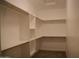Walk-in closet with built-in shelving and rods for organized storage at 2215 W Highland Ave, Phoenix, AZ 85015