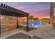 The backyard boasts a sparkling pool, outdoor kitchen, fire bowls, and a covered patio area at 22186 E Via Del Verde --, Queen Creek, AZ 85142
