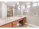 Well-lit bathroom with a vanity, dual sinks, and a view of the walk-in closet at 22186 E Via Del Verde --, Queen Creek, AZ 85142