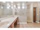 Bright bathroom featuring dual sinks, a large mirror, and a glass-enclosed shower at 22186 E Via Del Verde --, Queen Creek, AZ 85142