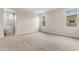 Carpeted bedroom with large windows and a view of the neighborhood and an ensuite bathroom at 22186 E Via Del Verde --, Queen Creek, AZ 85142