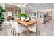 Bright dining room with a wood table, chandelier, and view into the kitchen and living area for seamless entertaining at 22186 E Via Del Verde --, Queen Creek, AZ 85142